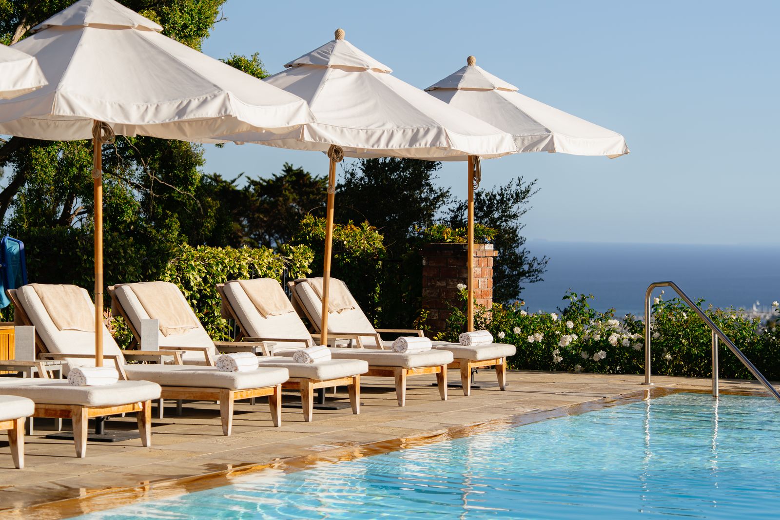 Poolside loungers and umbrellas above the ocean
