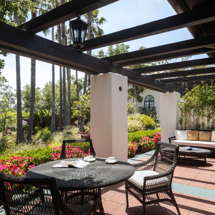 Pergola terrace with a table set for coffee